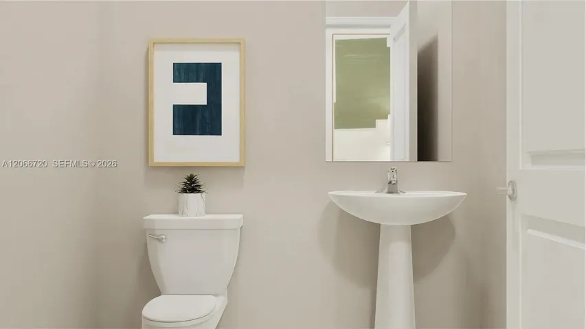 A powder room tucked off the foyer meets the needs of the whole household and visiting guests.