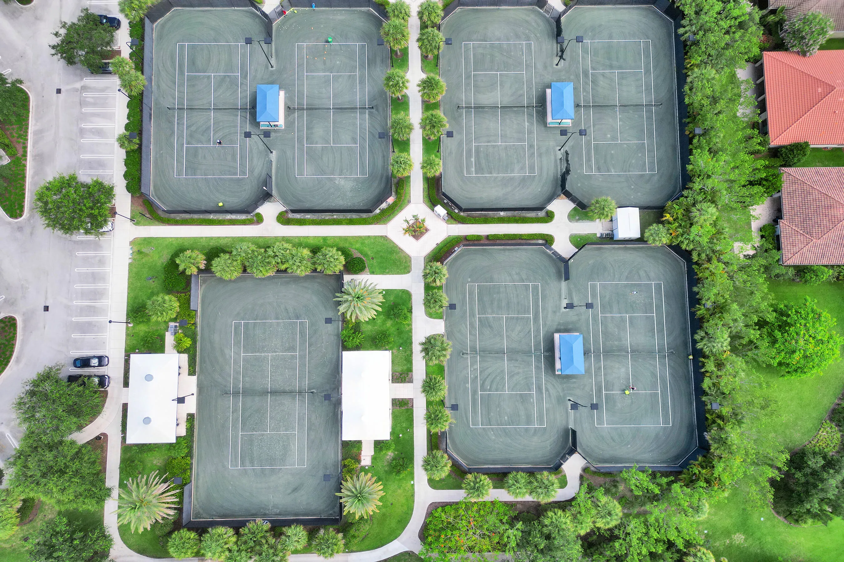 Four tennis courts featuring green surfacing