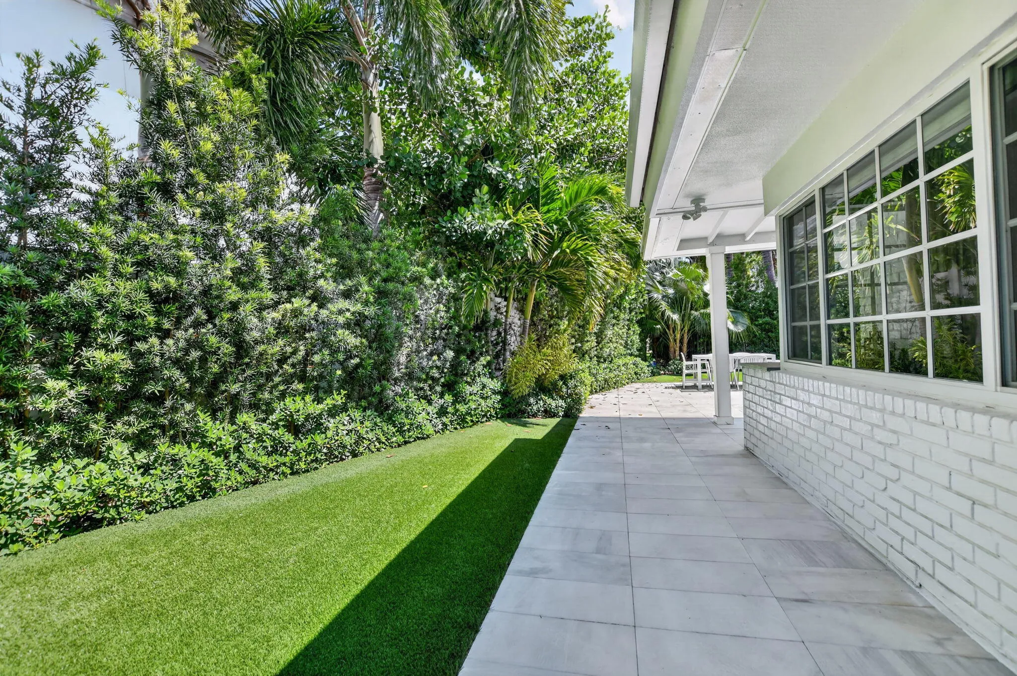 WEST SIDE ELEVATION: This photograph was taken from the Laundry Exterior door. This house is impeccably clean inside and out.