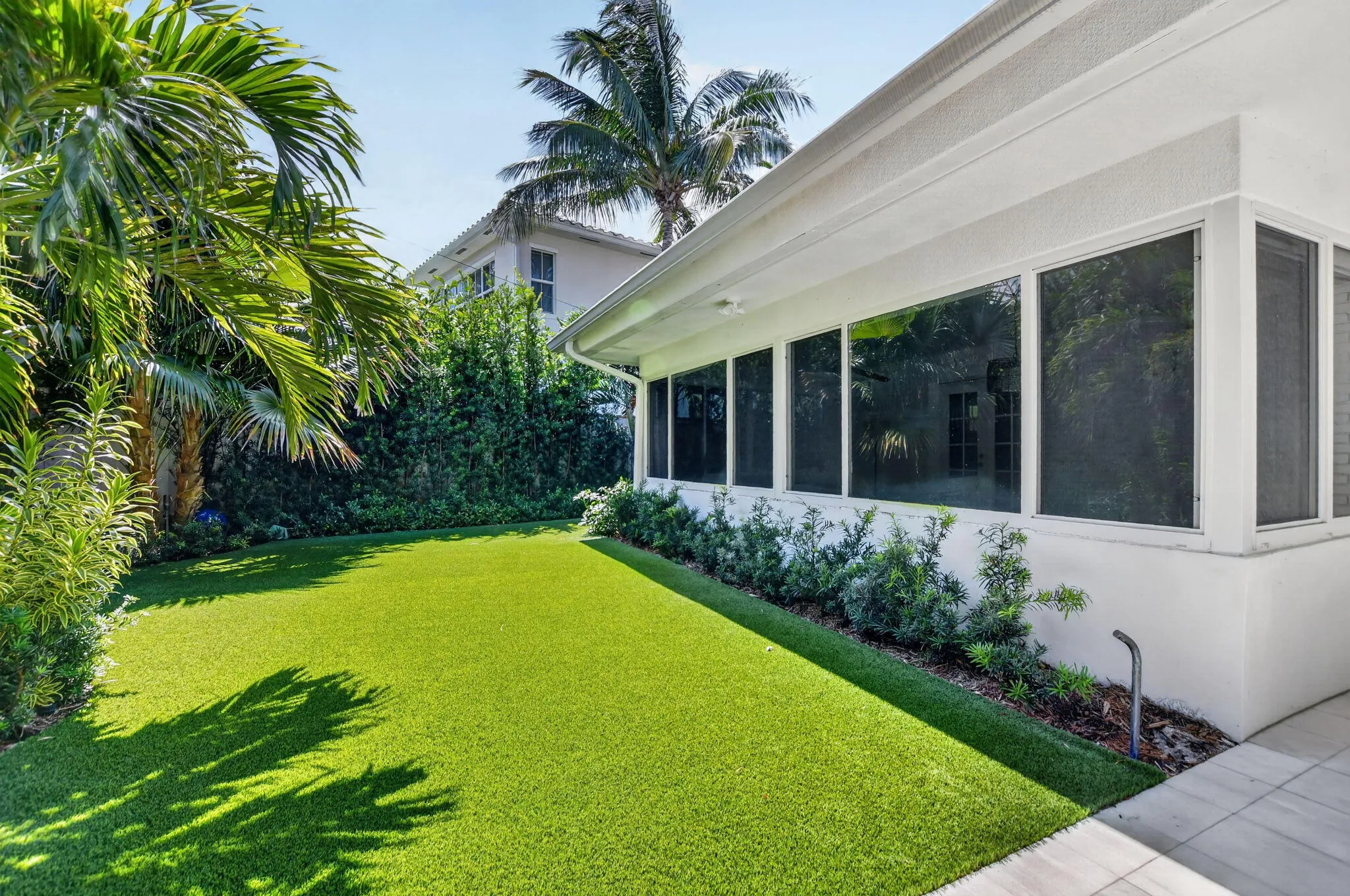 PRIVATE BACK YARD: This wall of new windows in the Sunroom offers a peaceful, calming view of this truly EVER-green very private oasis in the back yard ....