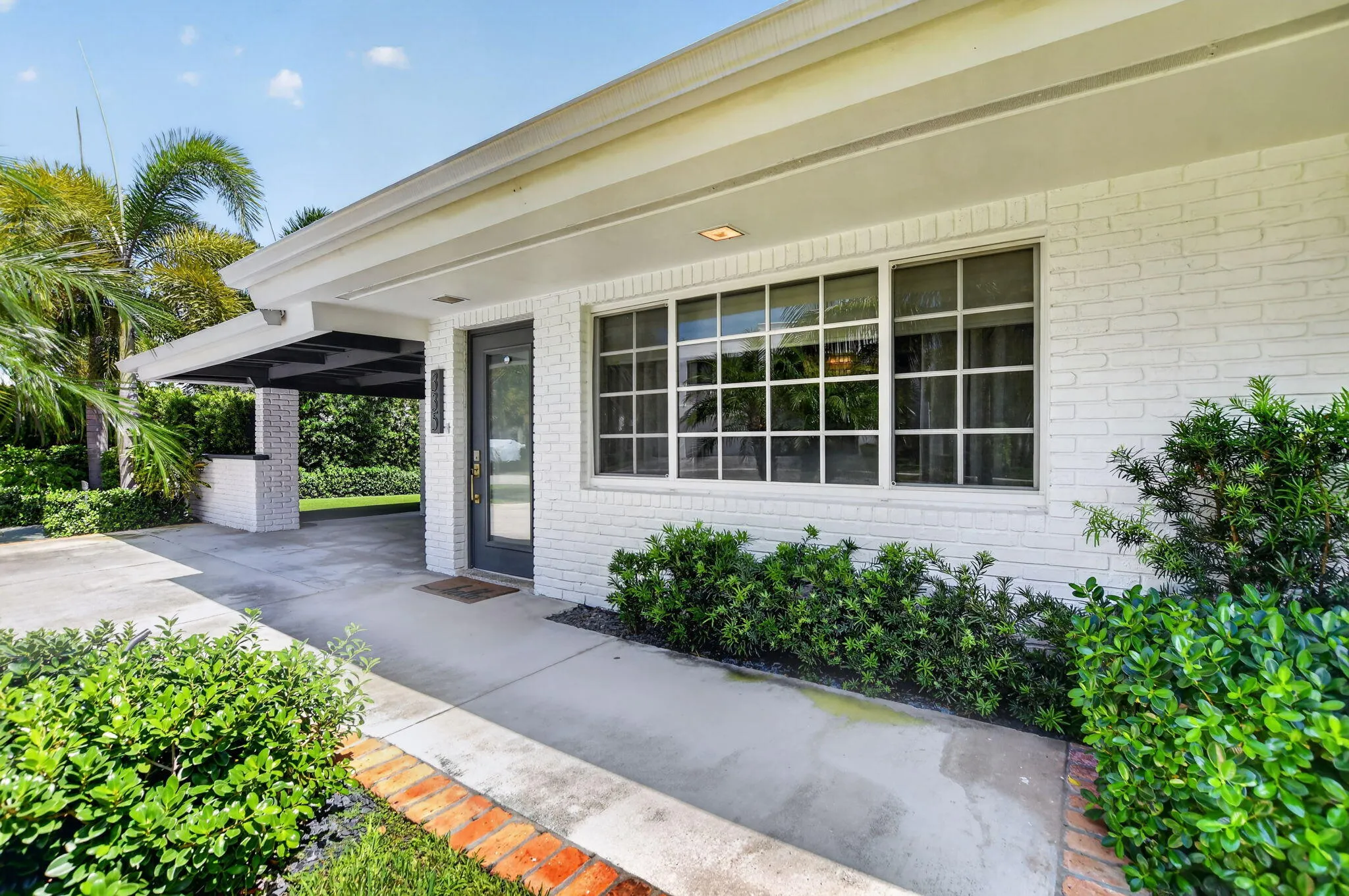 Front & South elevation offer a large set of windows streaming sunshine all day, The entrance area is covered by the roof keeping the rain drops and direct sun at a minimum. Your delivery drivers will thank you!