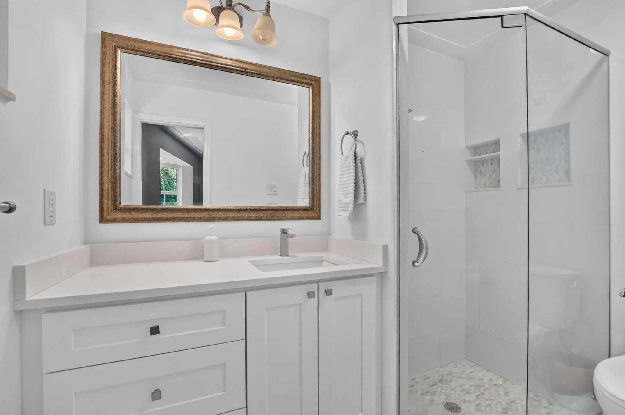 PRIMARY ENSUITE BATHROOM, Newly installed vanity with tons of storage spaces, brightly tiled and has a sunny east window too!