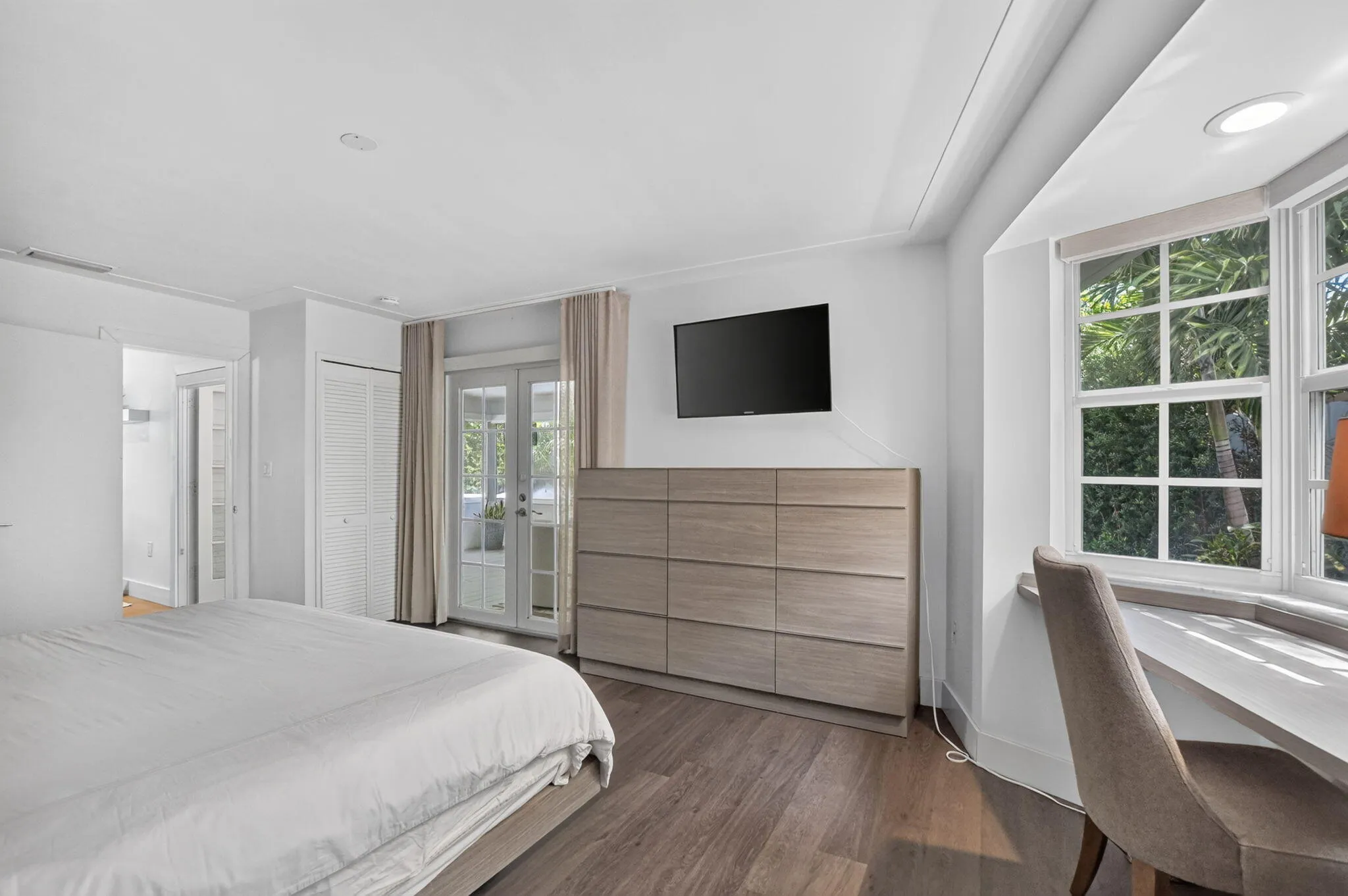 PRIMARY BEDROOM: .. YES! in case you were wondering .. Private French doors open up to the calming spaces aka Sunroom.