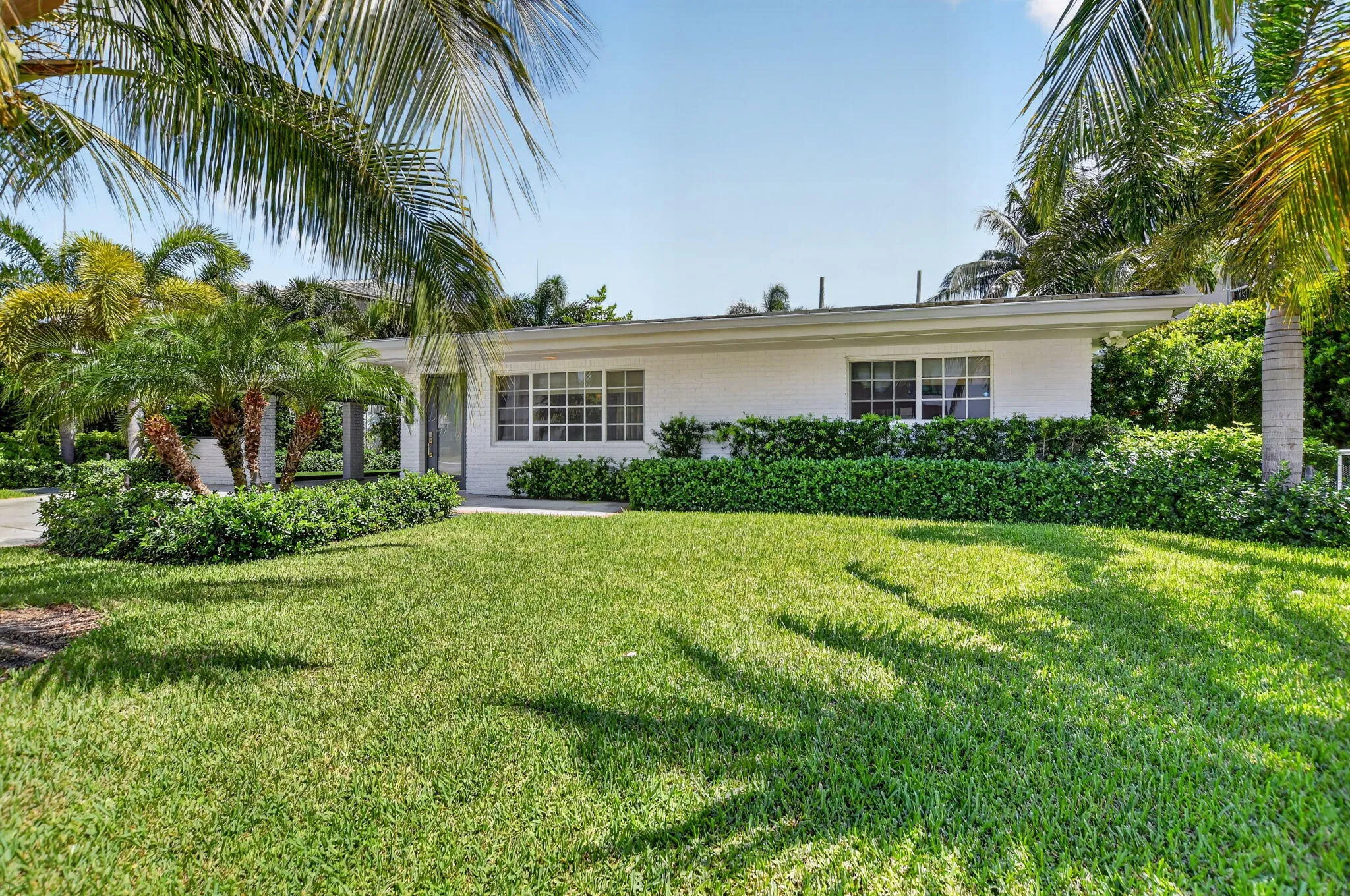 This Florida home offers many swaying palm trees that offer breezy shaded areas around the property!