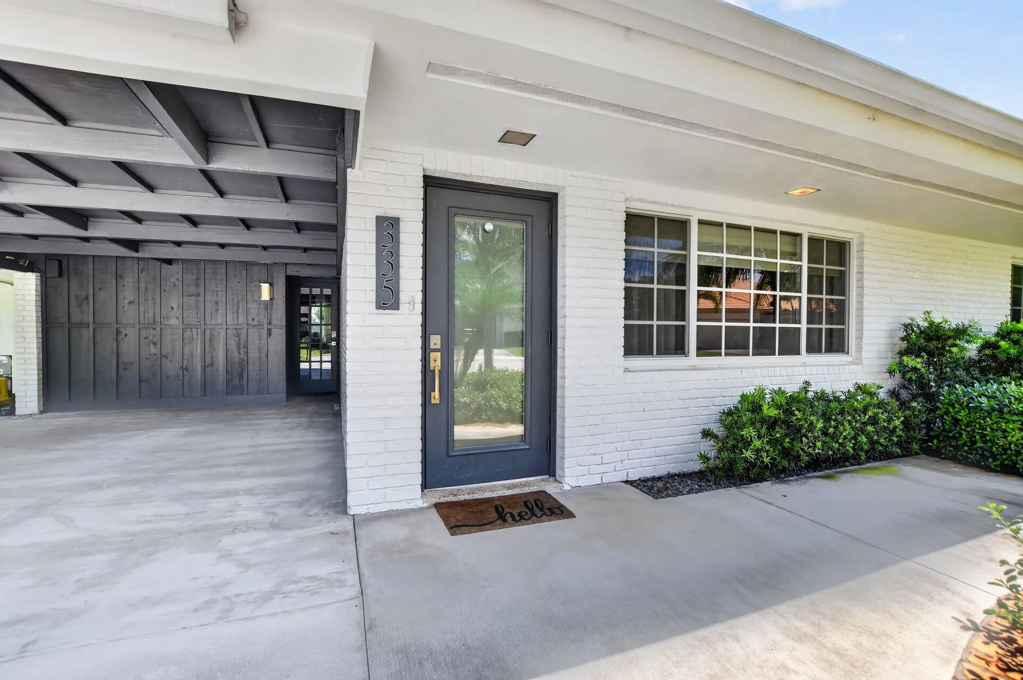 The South-facing front of the home has a a Covered frosted glass impact resistant front door that allows sunlight into the home throughout the day.