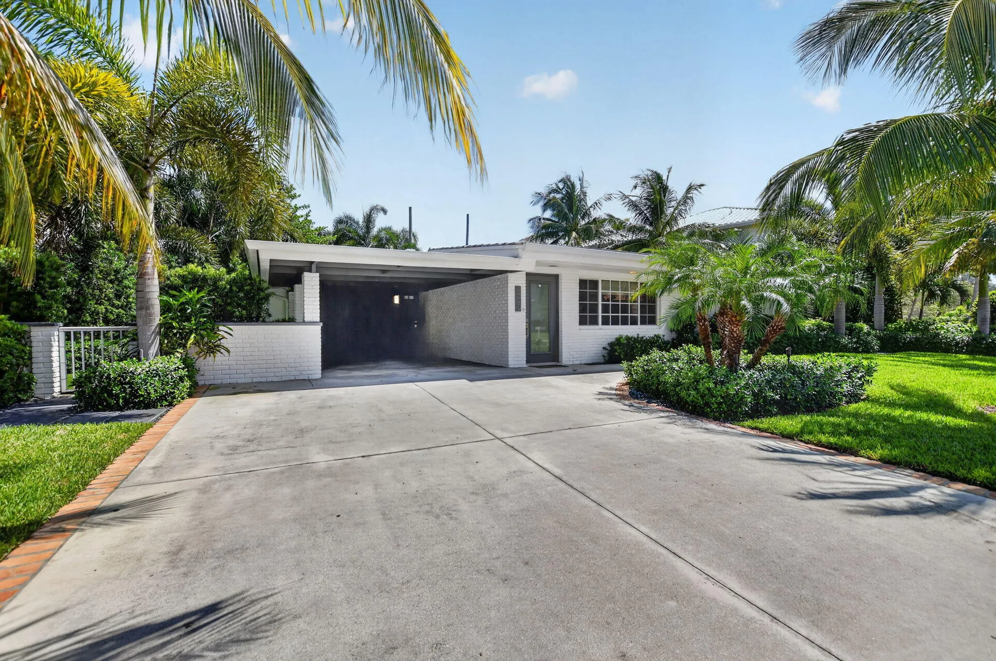 Take a look at this concrete oversized driveway and much needed carport with an entrance door to home. This carport includes an electric car charger.