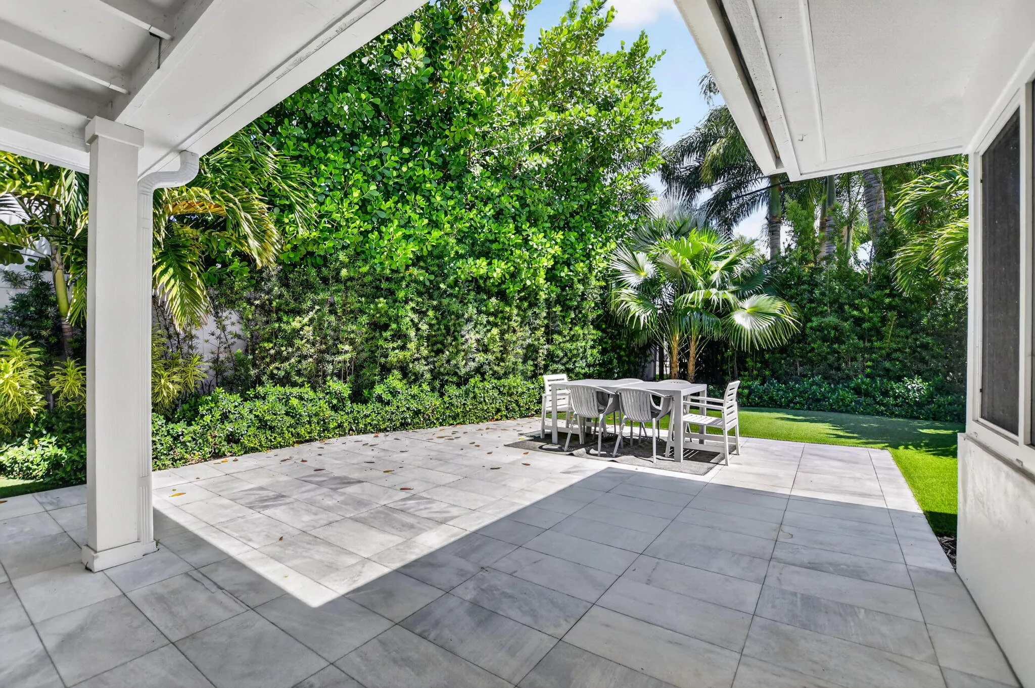 COVERED BACK PATIO area is perfect when you want to be in the shade or just out of the rain, This large newly installed patio area has the best of both weather conditions!