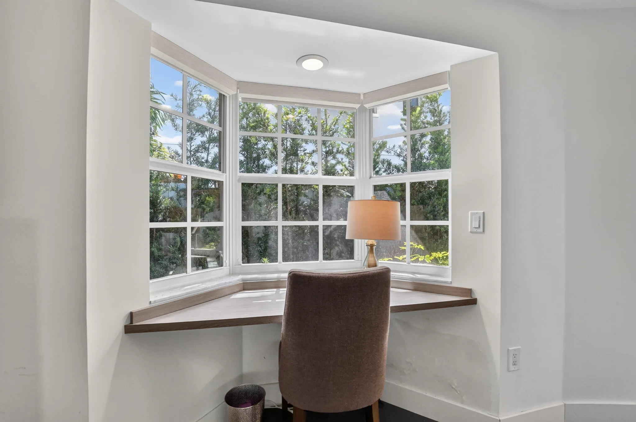 PRIMARY BEDROOM: This sunny Bay window offers a built-in desktop. Just bring your laptop, journal, morning to-do list and don't forget your morning coffee! This inviting space has an overhead light (on a dimmer) to save on desk space!