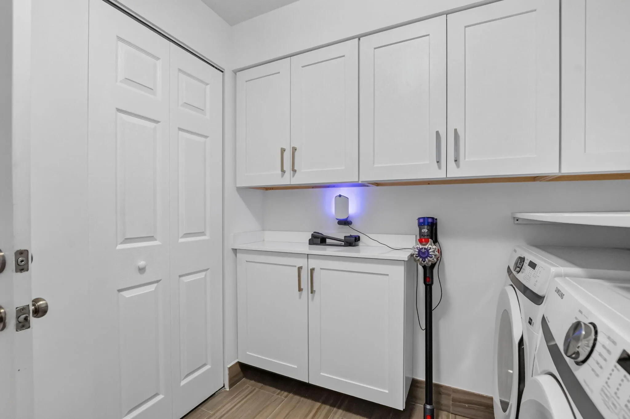 Current owner recently renovated this bright laundry room space. New Washer & Dryer installed, lots of new cabinets, a broom/ironing board closet, a new laundry tub/sink, new impact window & shade and this room has an exterior door to the back patio area!