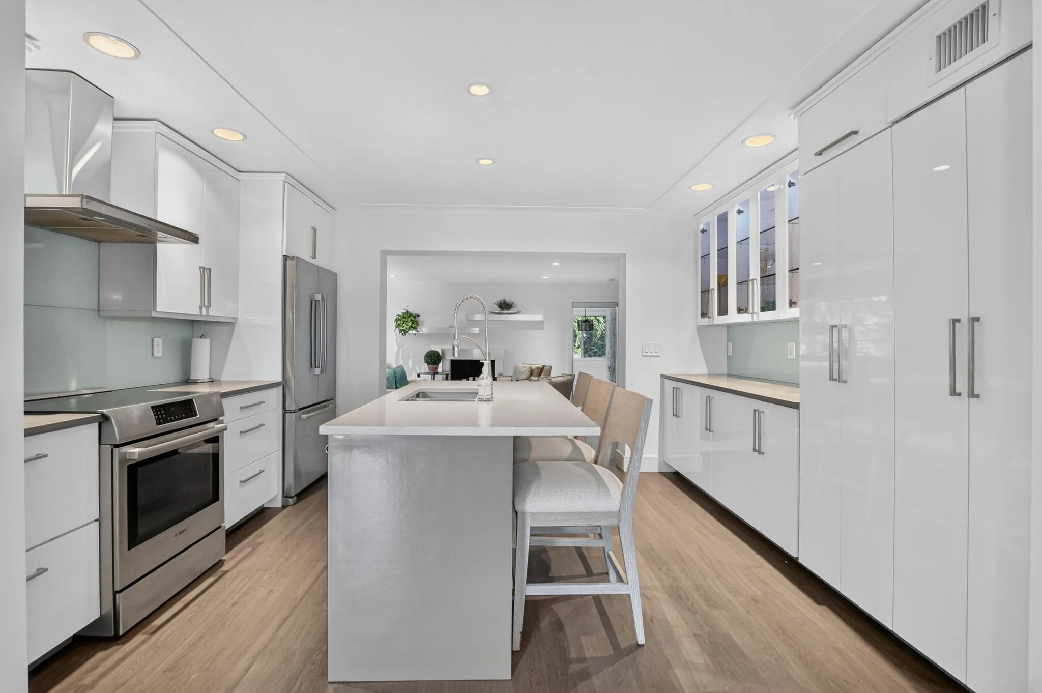 This updated kitchen has plenty of cabinets with pullouts, glass overhead illuminated cabinets, numerous pull out drawers and shelves too.