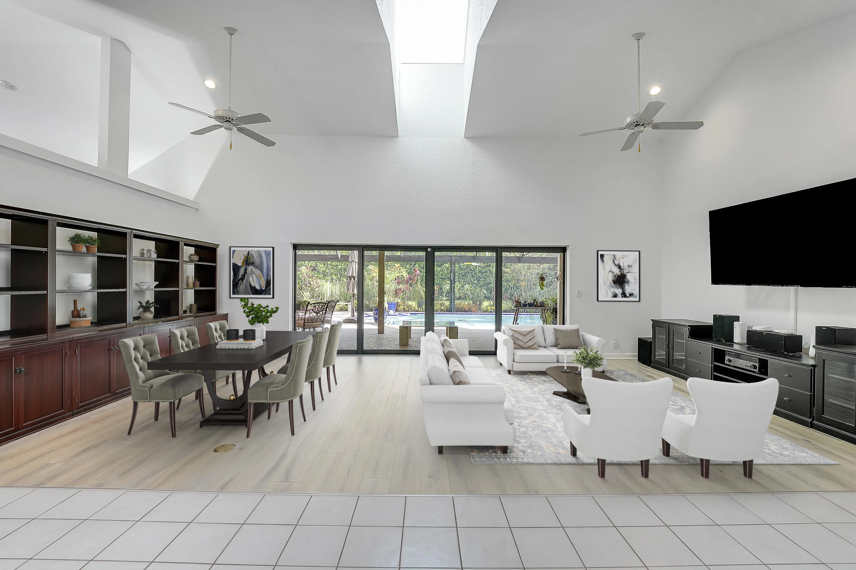 Front entry to a spacious great room featuring vaulted ceilings, abundant natural light, and seamless views of the pool and lush backyard. *virtually staged*