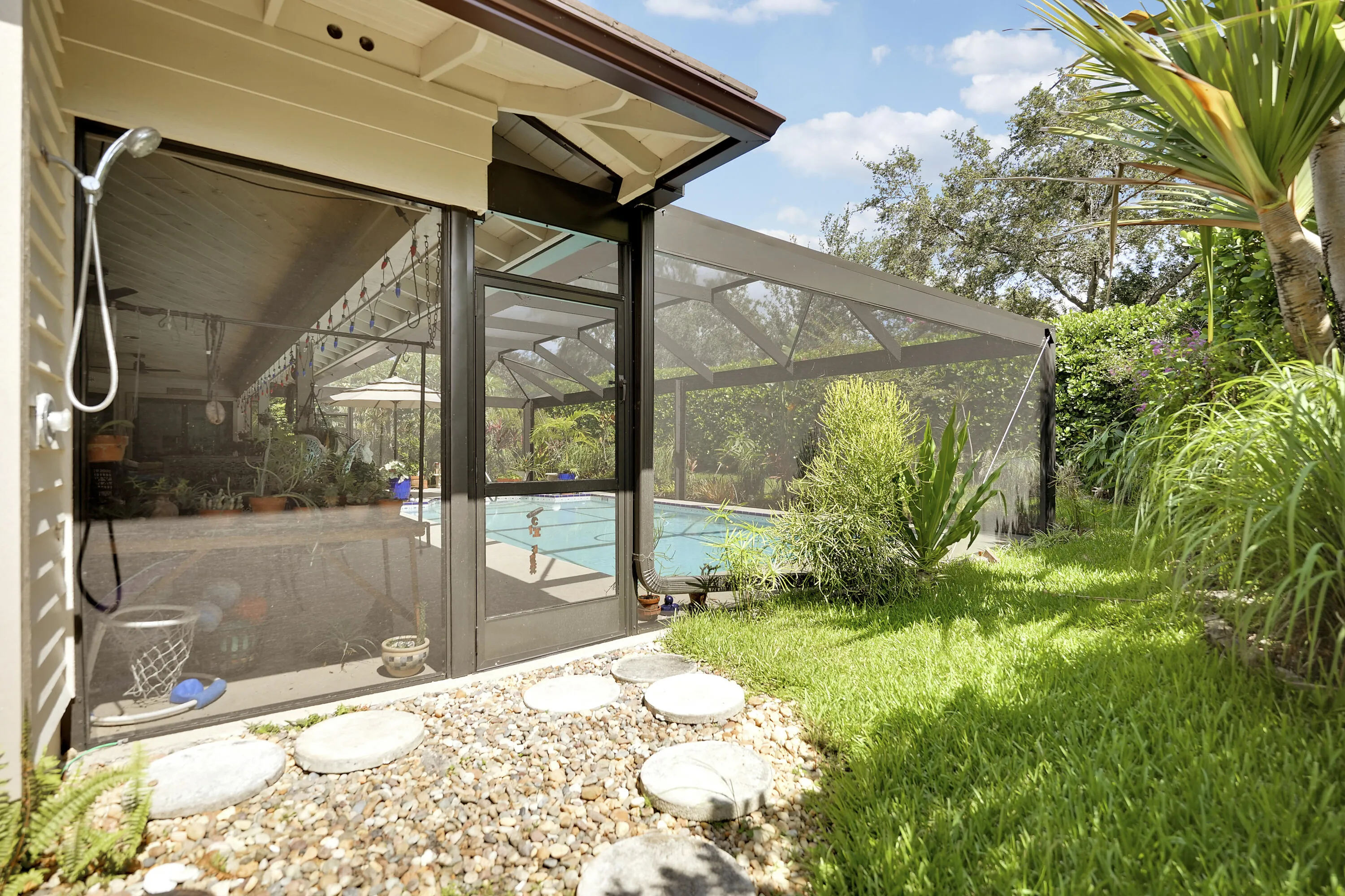 Outdoor shower offers a convenient space to rinse off after pool time, beach days or outdoor work. Located just outside the screened patio, it adds functionality and comfort to the home’s outdoor living experience.