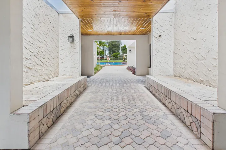 Covered outdoor walkway featuring a wood-finish ceiling