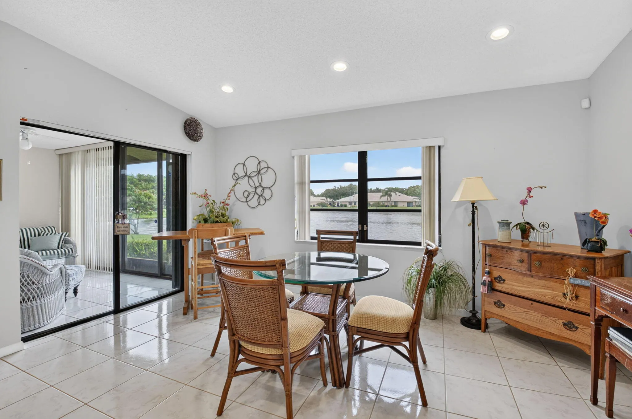 Recessed lighting illuminates the tiled flooring and light-toned walls