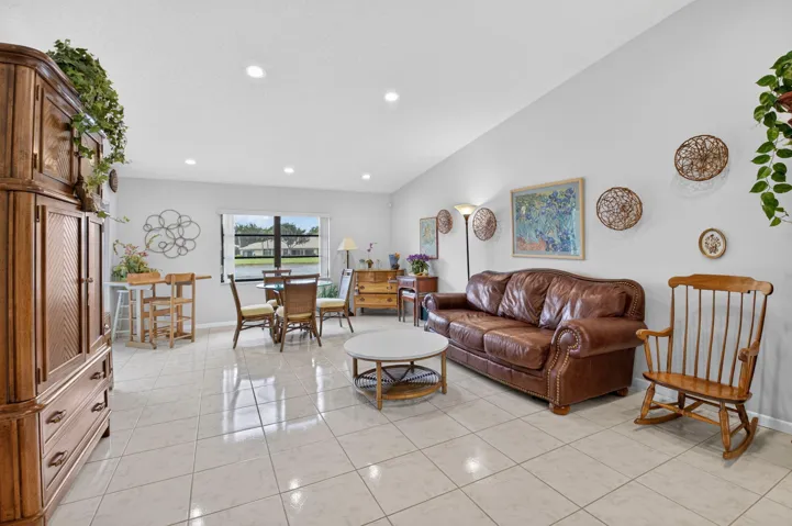 Recessed lighting, light-toned tile flooring, and a large window