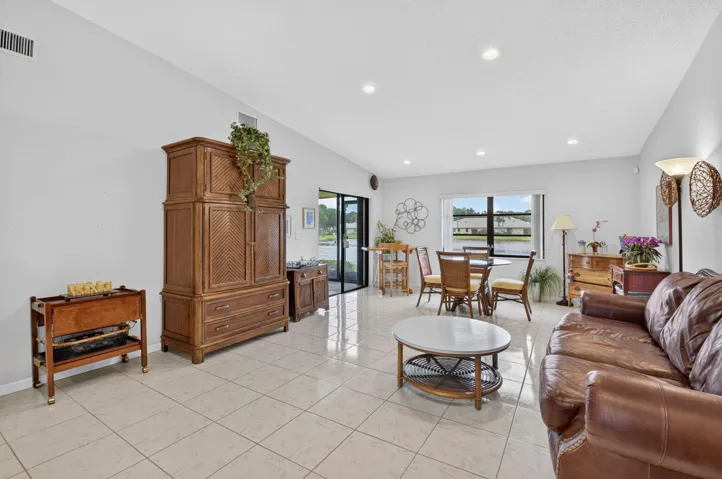 Tile flooring, vaulted ceiling, recessed lighting, expansive window, water views