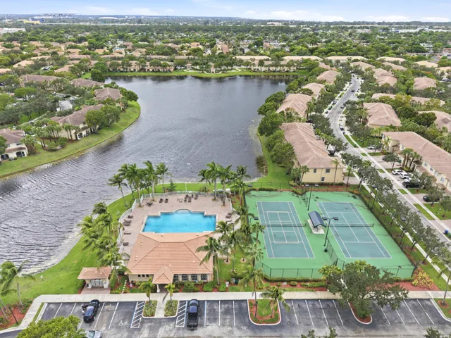 Community amenities featuring a swimming pool, two tennis courts, and a clubhouse