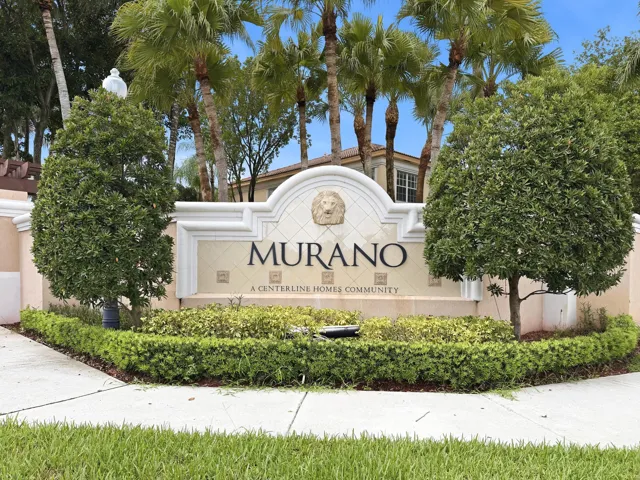 Community signage featuring sculpted landscaping and architectural details