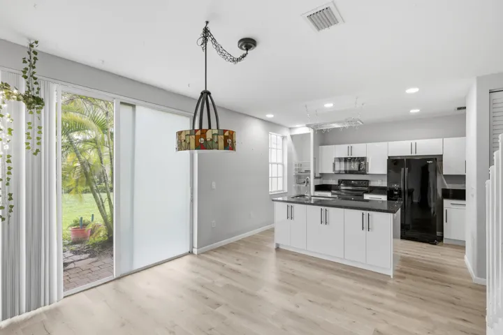 Open-concept layout featuring wood-finish flooring and a contemporary kitchen