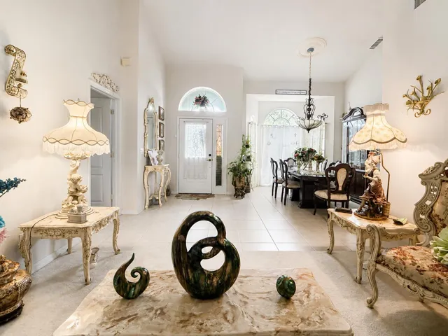 Arched transom windows, recessed lighting, and tile flooring