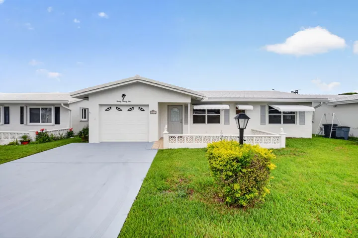 Home facing south with attached garage and wide driveway.