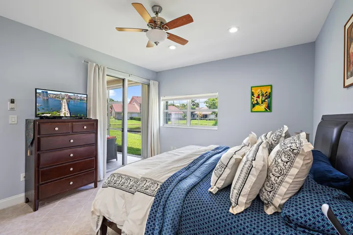 Primary bedroom with floor to ceiling sliding door to your private porch