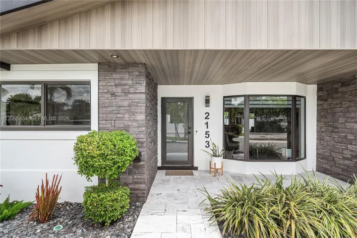 Stone work/ treated wood panels/ bay window