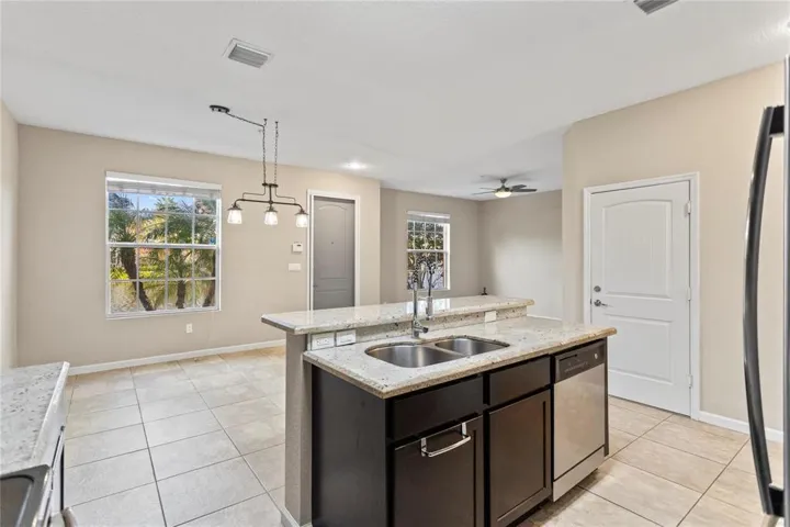 Open kitchen concept with granite counter-top dining, view of fountain lake.
