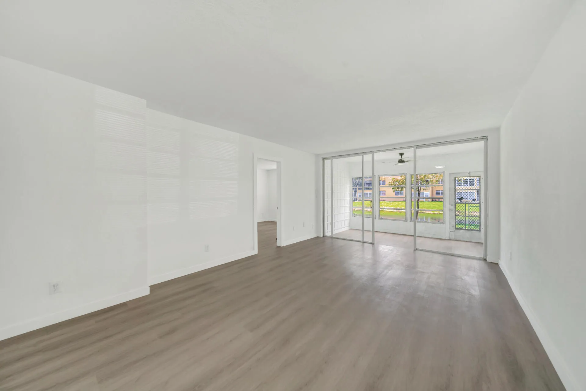 Dining Room & Living Room with entry to Enclosed Sun Room.