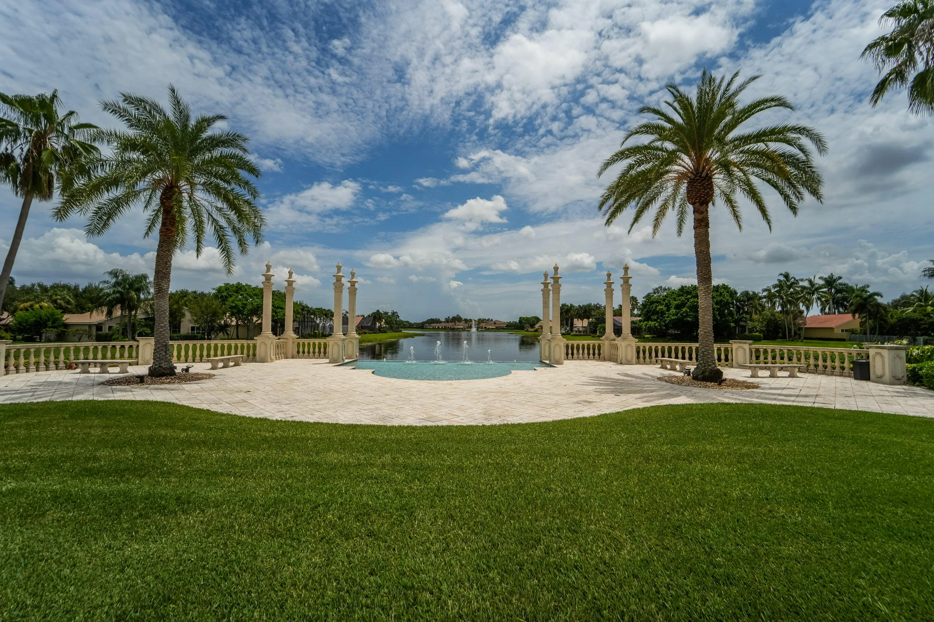Signature entrance water feature creates a striking arrival, visually blending toward the lake beyond.