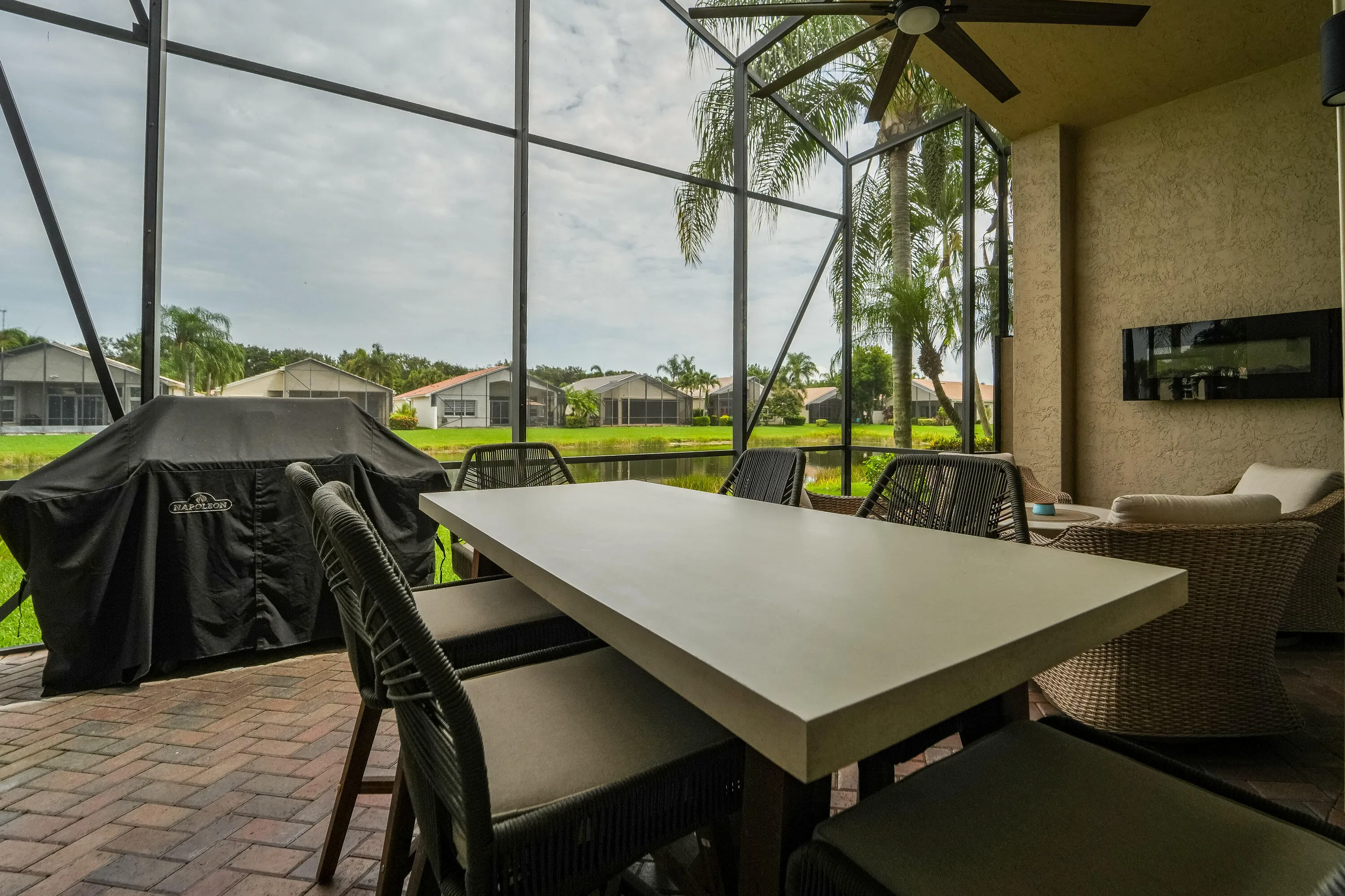 Screened outdoor living creates a peaceful setting for dining, relaxing and enjoying the lakefront lifestyle.
