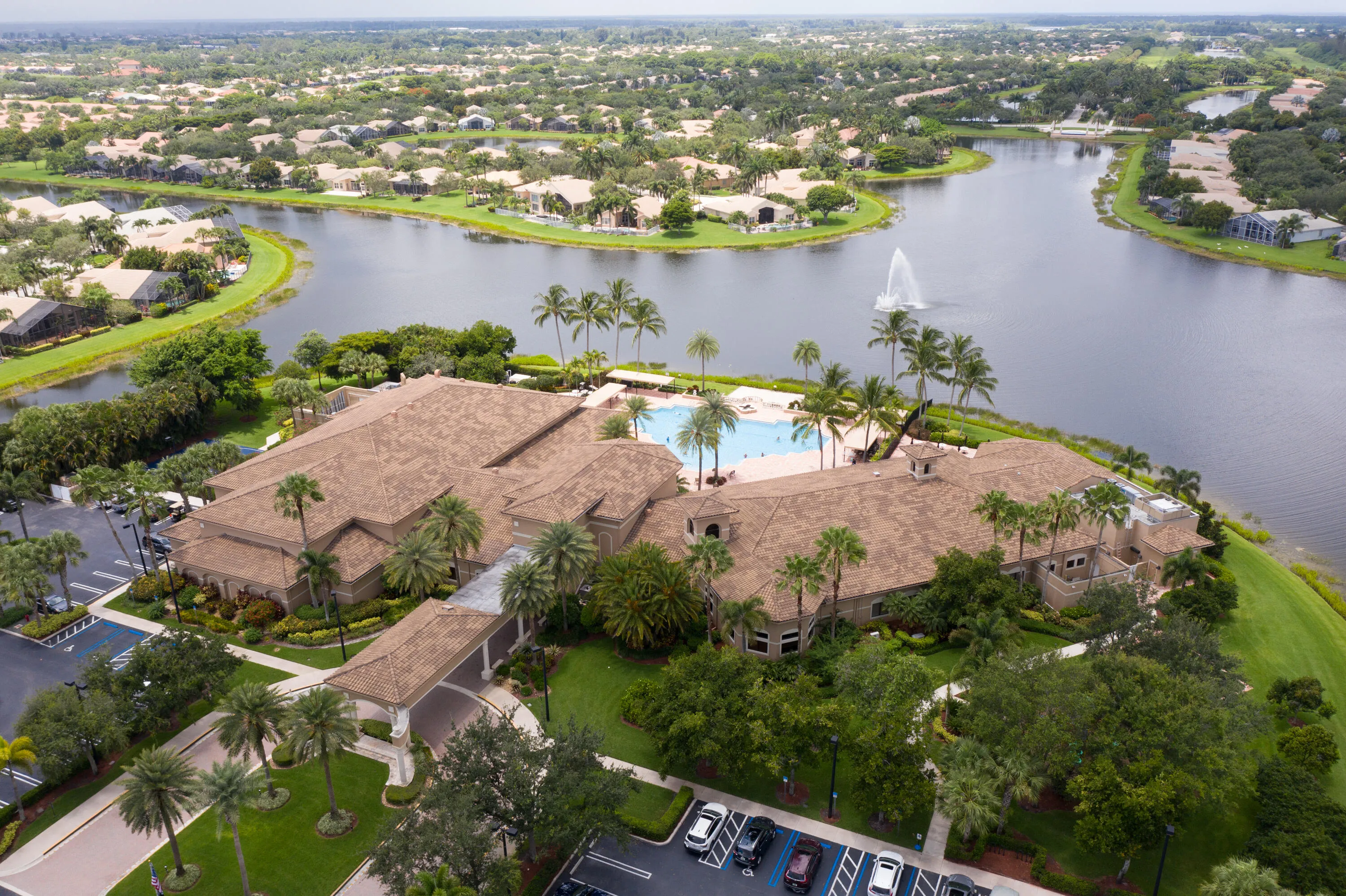 Aerial view of the Social Club, resort-style pool and surrounding lakefront setting at Valencia Shores.