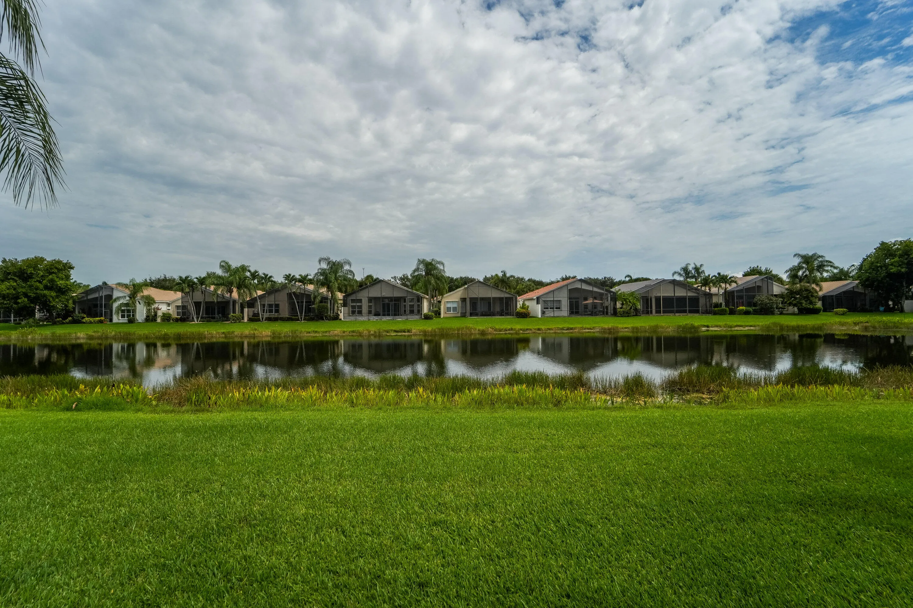 Tranquil lake views create a relaxing backdrop from the rear of the home.