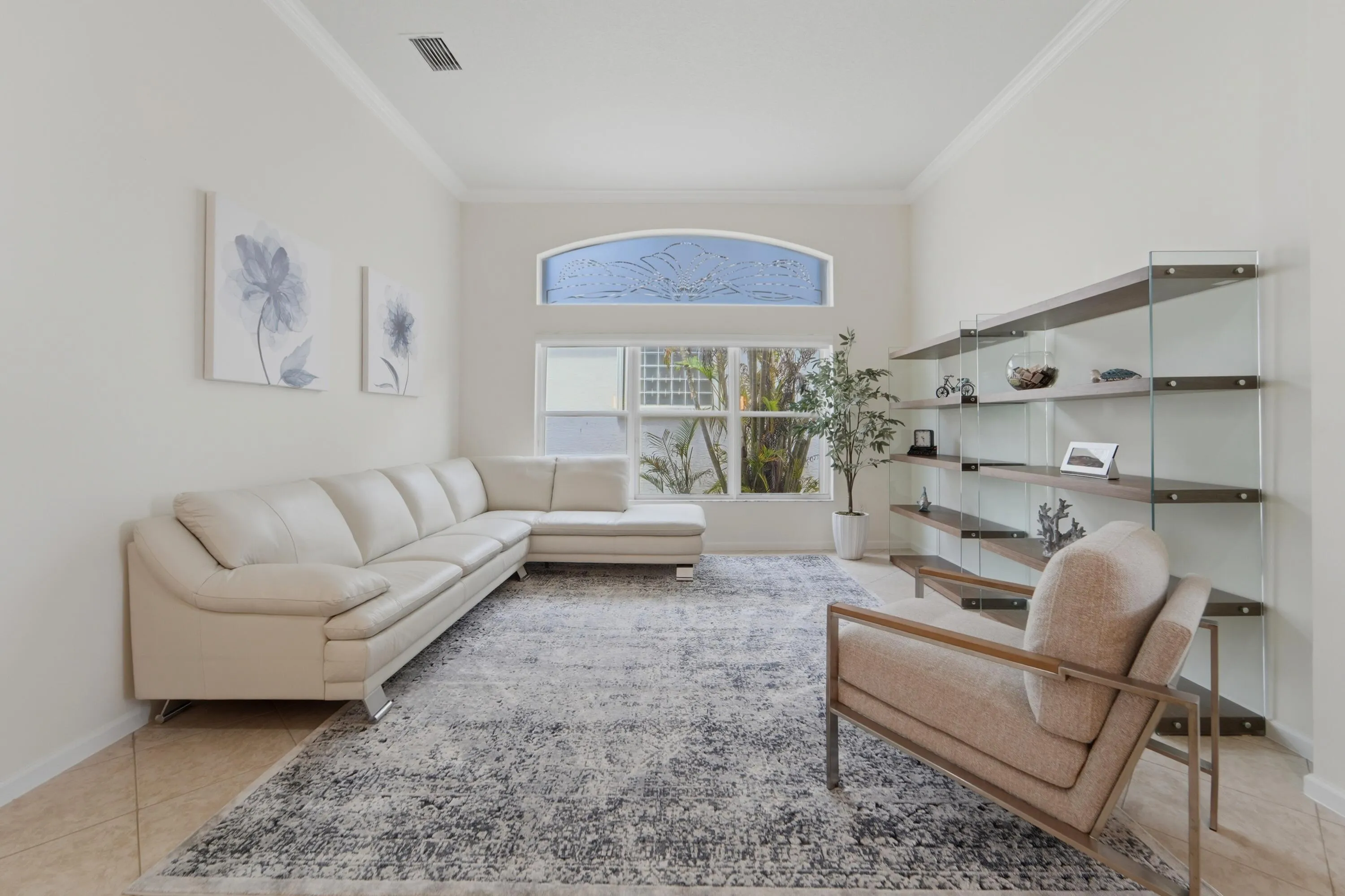 Volume ceilings and abundant natural light create an airy, inviting formal living space.