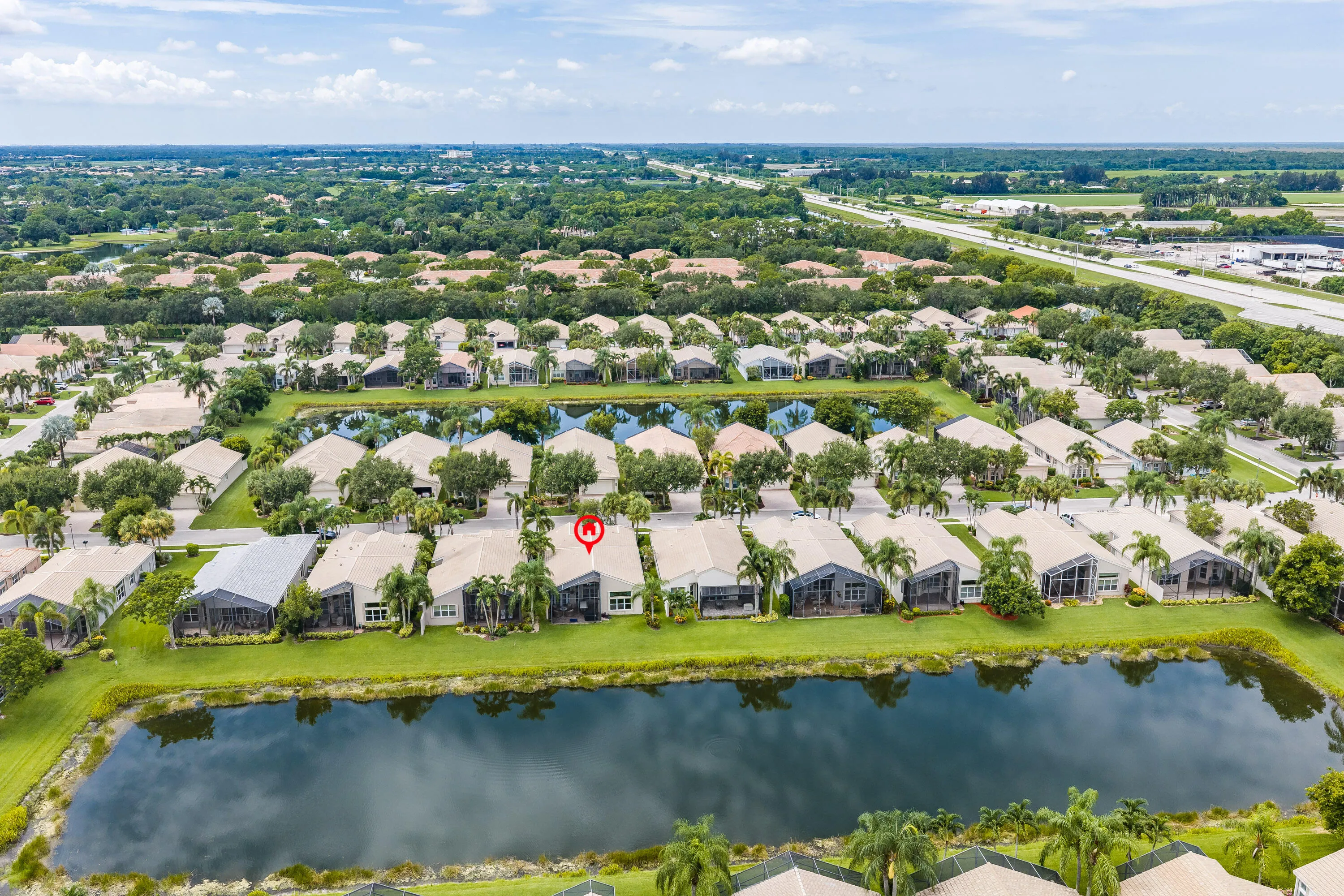 Aerial view pinpoints 9841 Casa Mar Drive and shows its enviable position just steps from the lake.