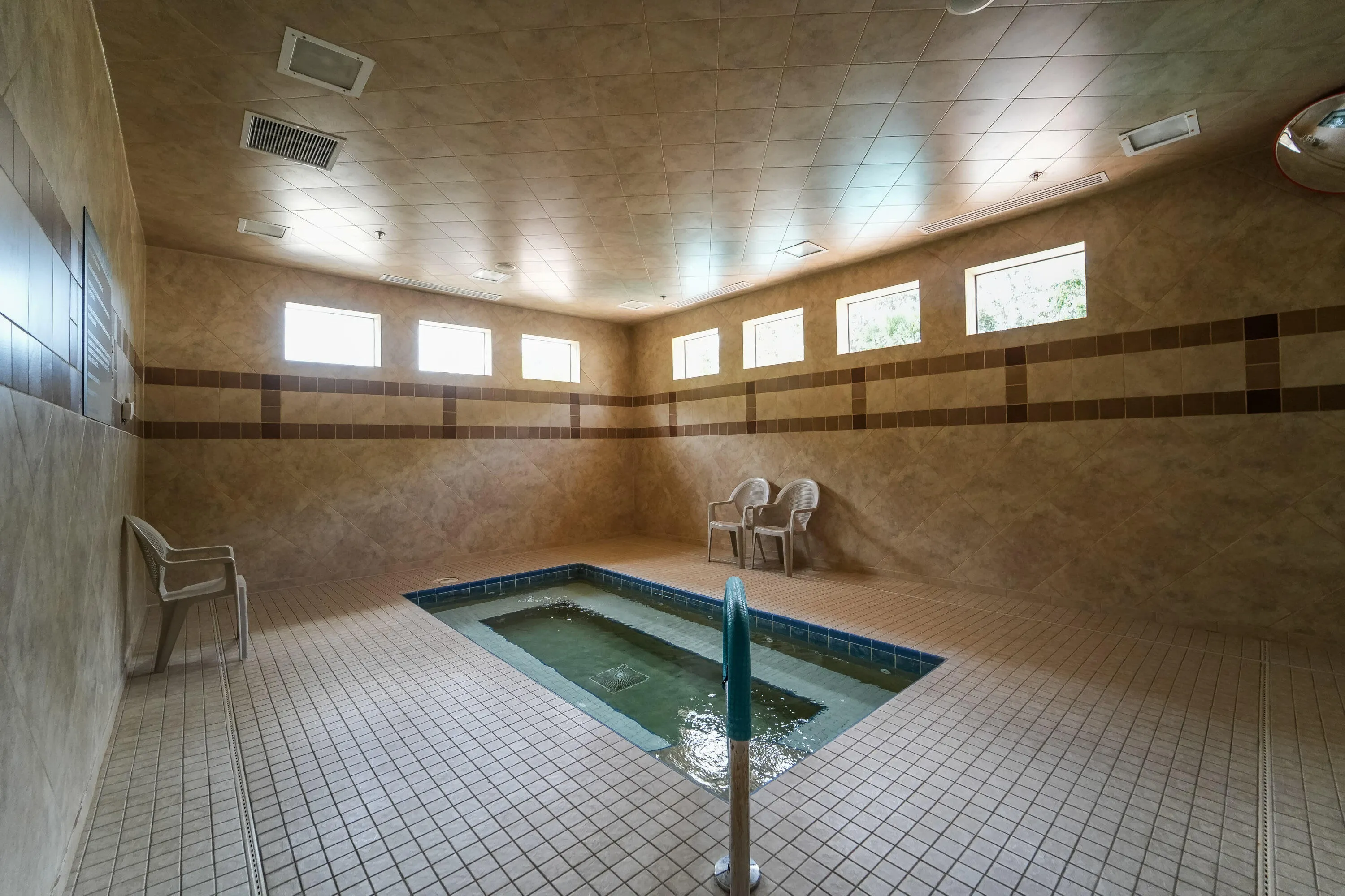 Shared indoor hot tub adds a relaxing wellness amenity within the Athletic Club.