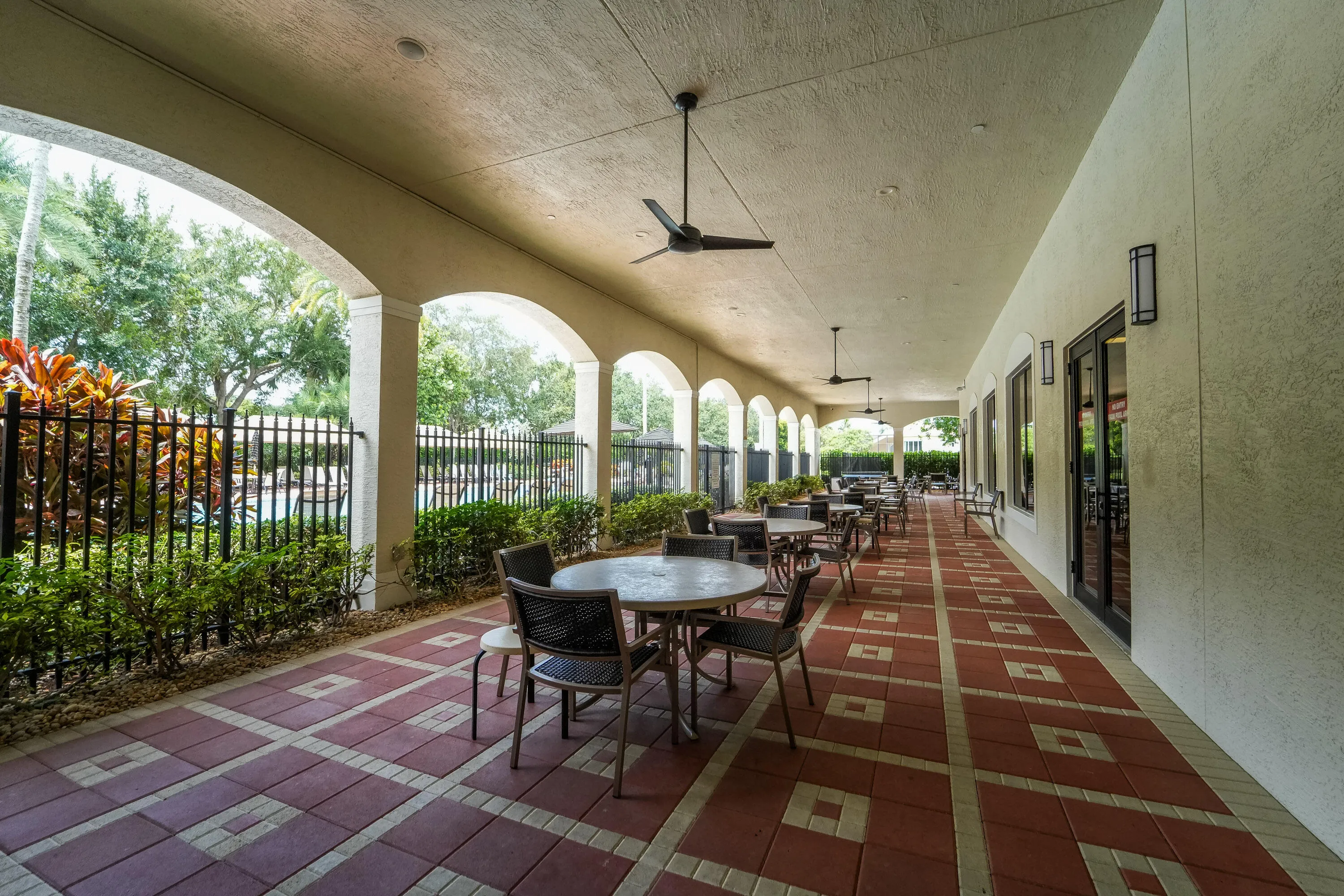 Covered outdoor seating extends the Social Club lifestyle outdoors with space to relax and socialize near the lake.