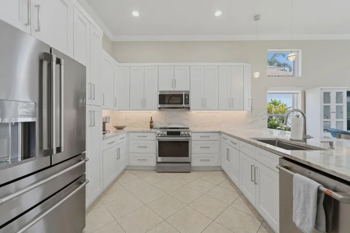 Thoughtfully designed kitchen offers abundant cabinetry, stainless steel appliances and generous prep space.