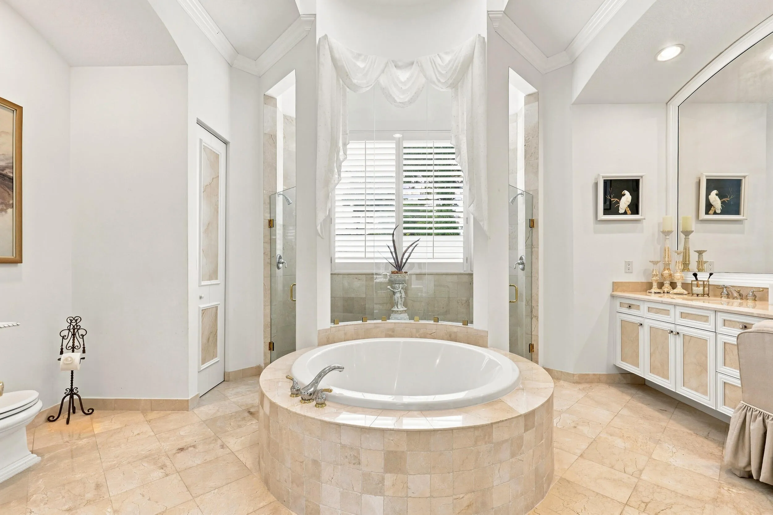 1 of 2 primary bathrooms with large shower area and bathtub