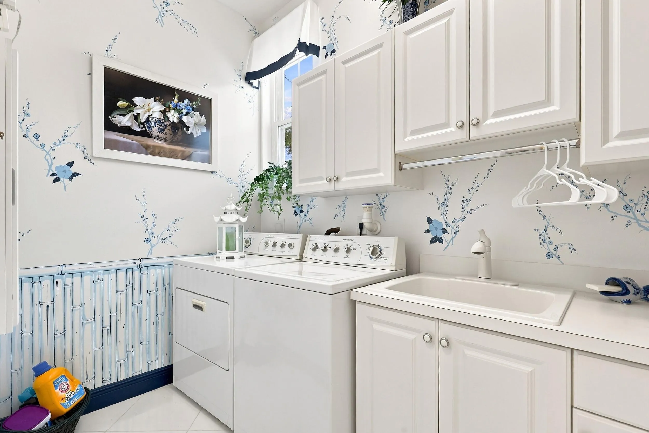 Large laundry room on 1st floor with sink and plenty of cabinets