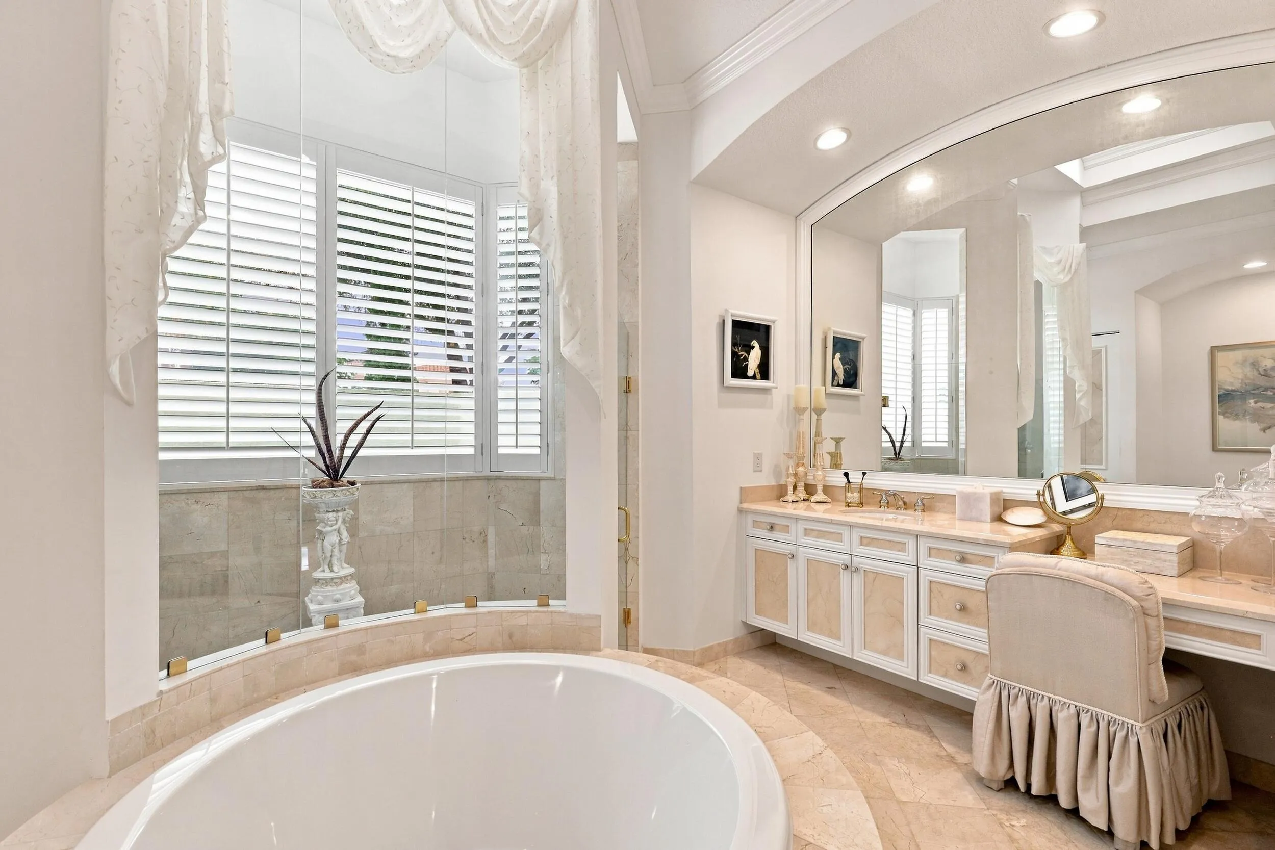 1 of 2 primary bathrooms with large shower, cosmetic area and natural light