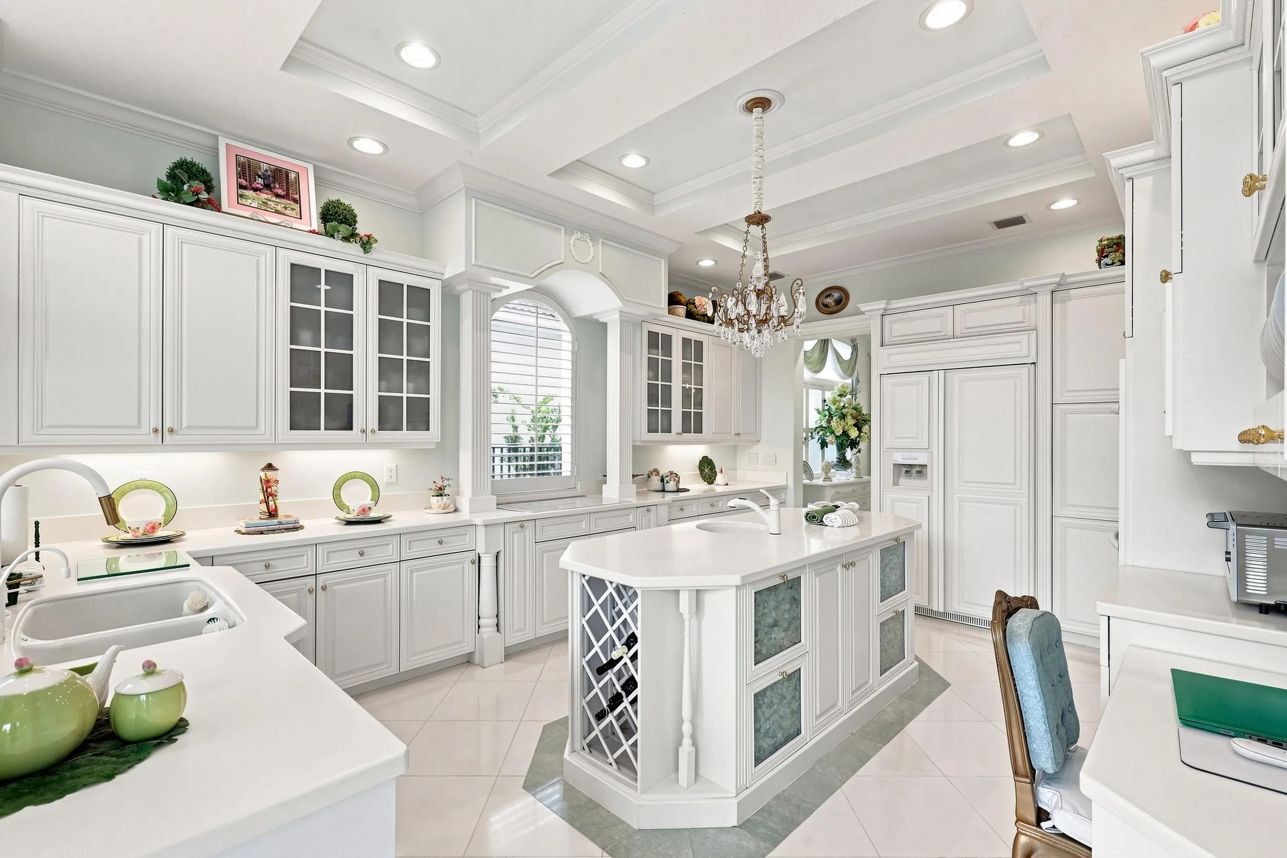 Custom built white cabinets with walk in pantryl, office desk area, with built in refrigerator