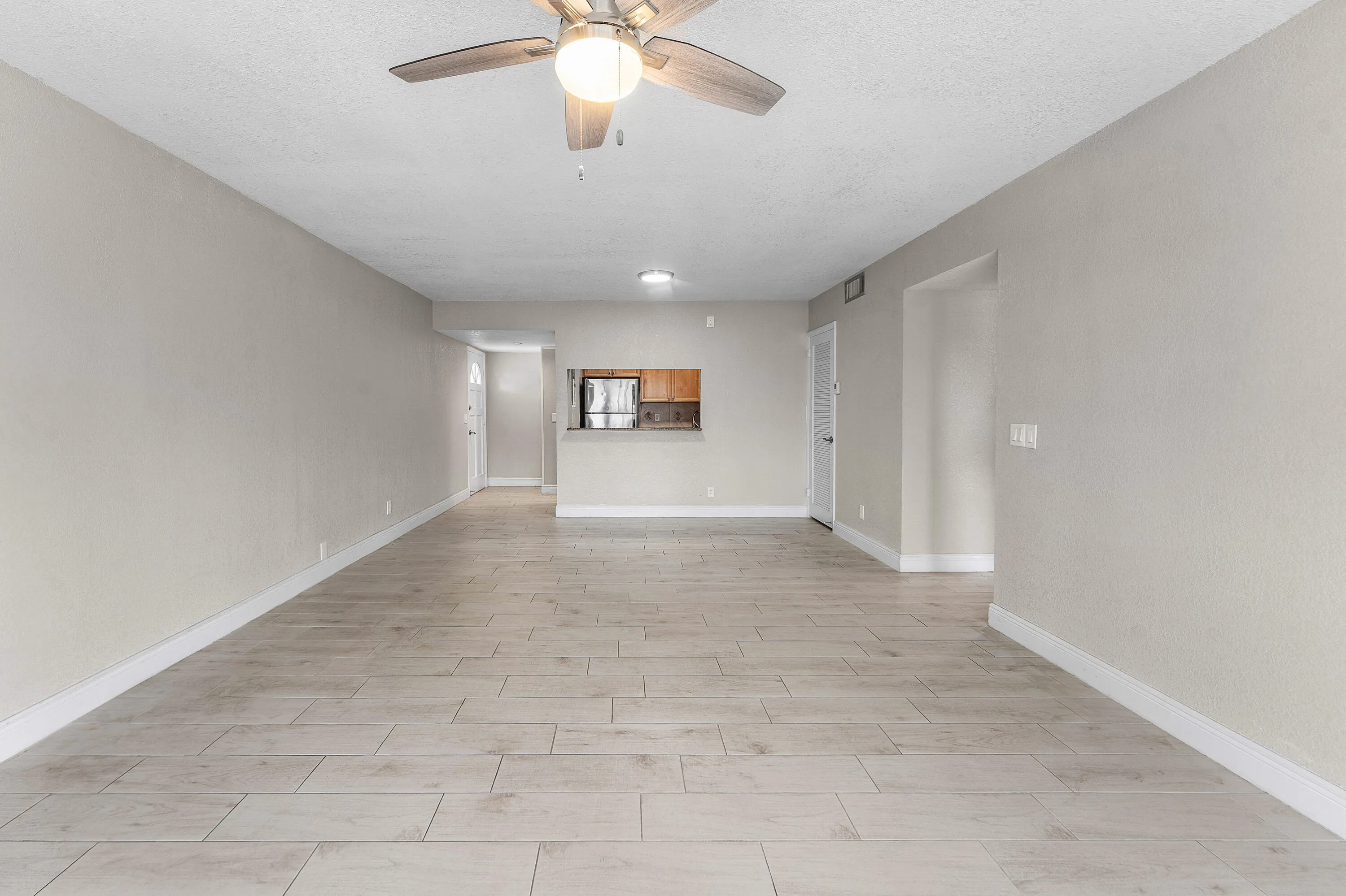 Recessed lighting, wood-finish ceiling fan, neutral paint, tiled flooring, built-in pass-through window