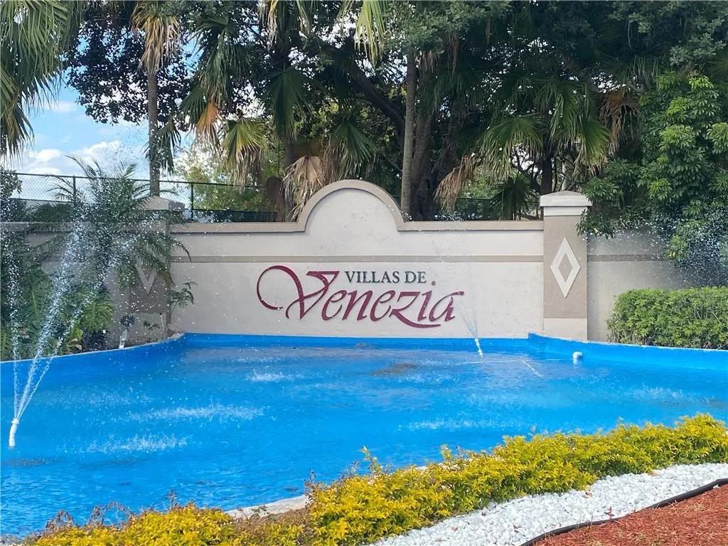 Community entrance with a decorative water feature and established landscaping