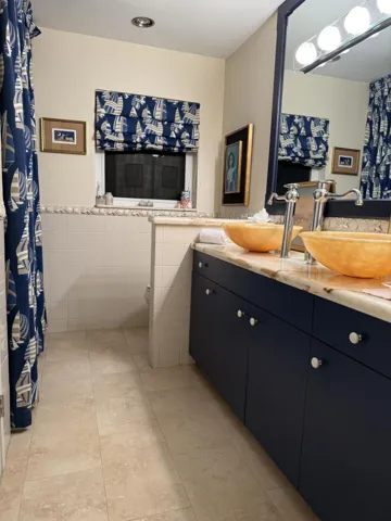 2nd Bathroom with tub shower combo and dual sinks.