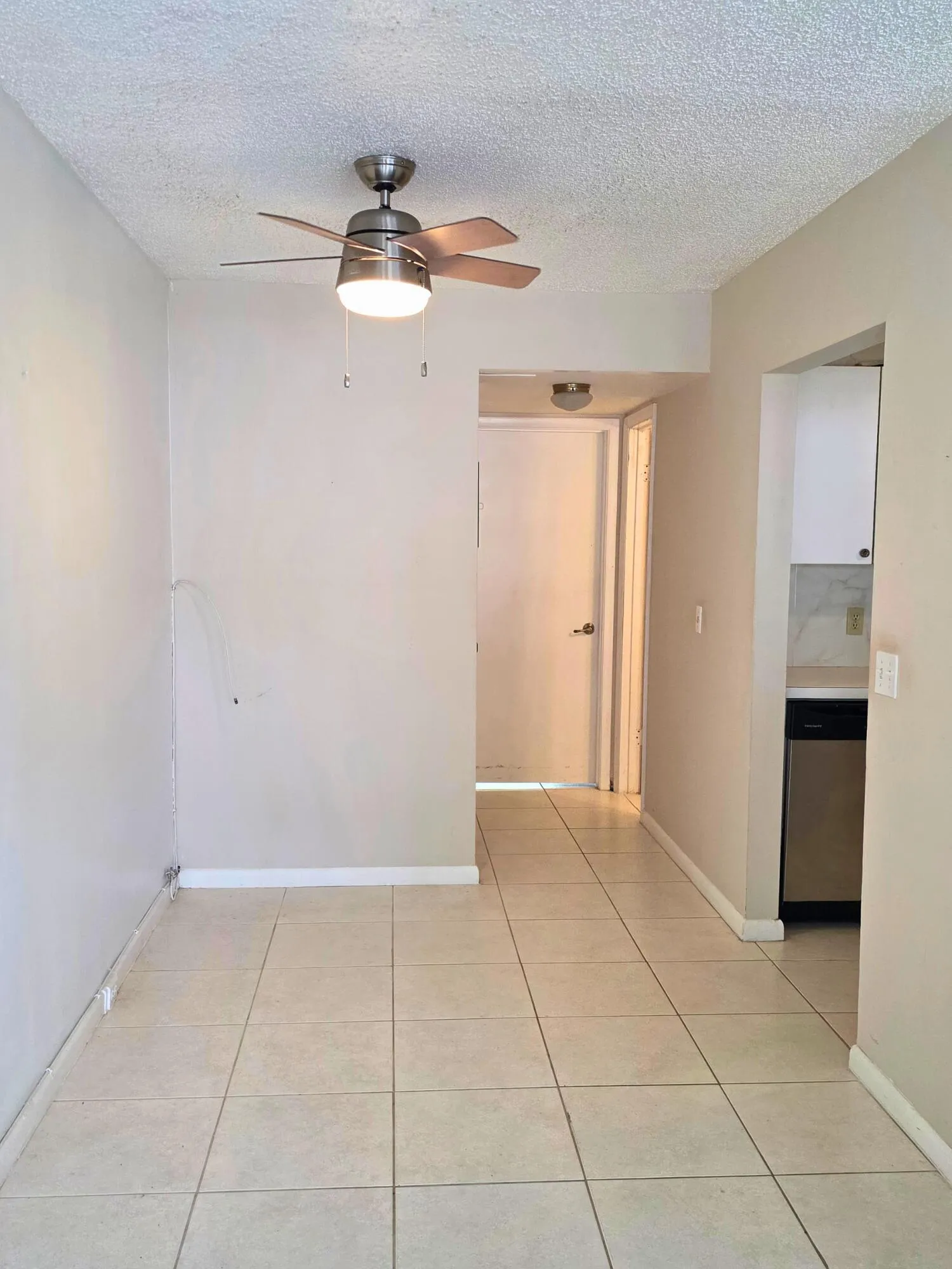 Recessed lighting, ceiling fan, tile flooring, white cabinetry, and stainless steel dishwasher