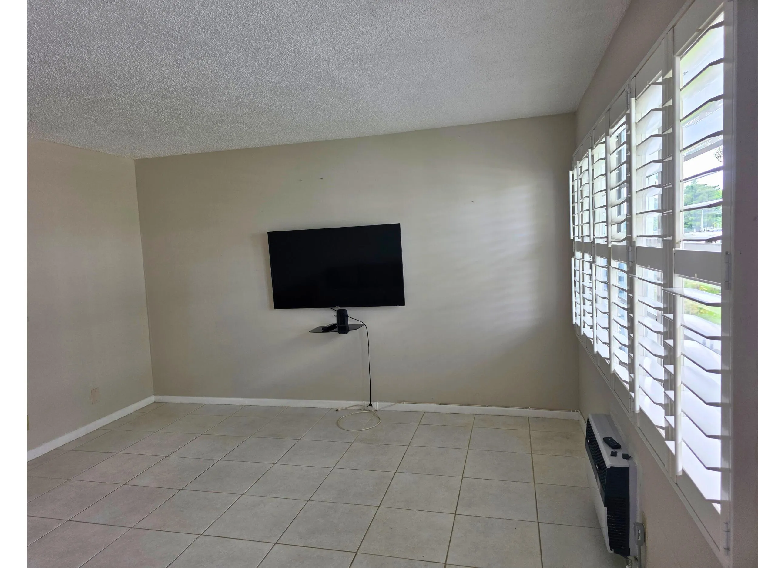 Neutral-toned walls complement the light-colored tile flooring
