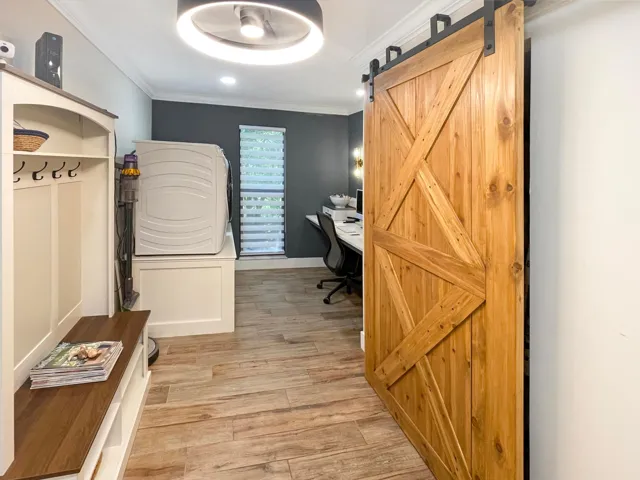 Barn doors cover the huge kitchen pantry next to the laundry area and home office nook