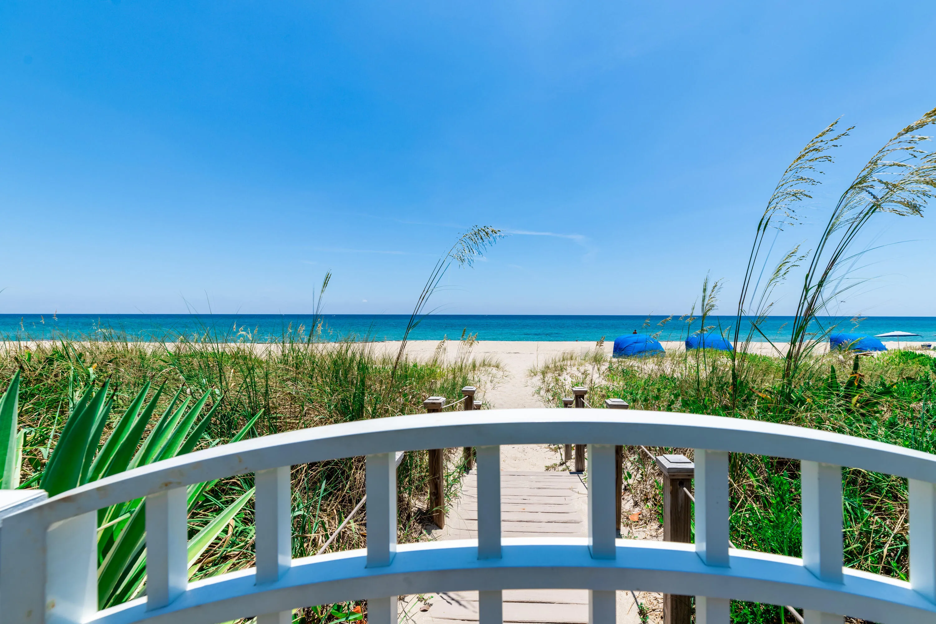 Gated beach access leads to sandy white beaches where you can relax in a covered cabana