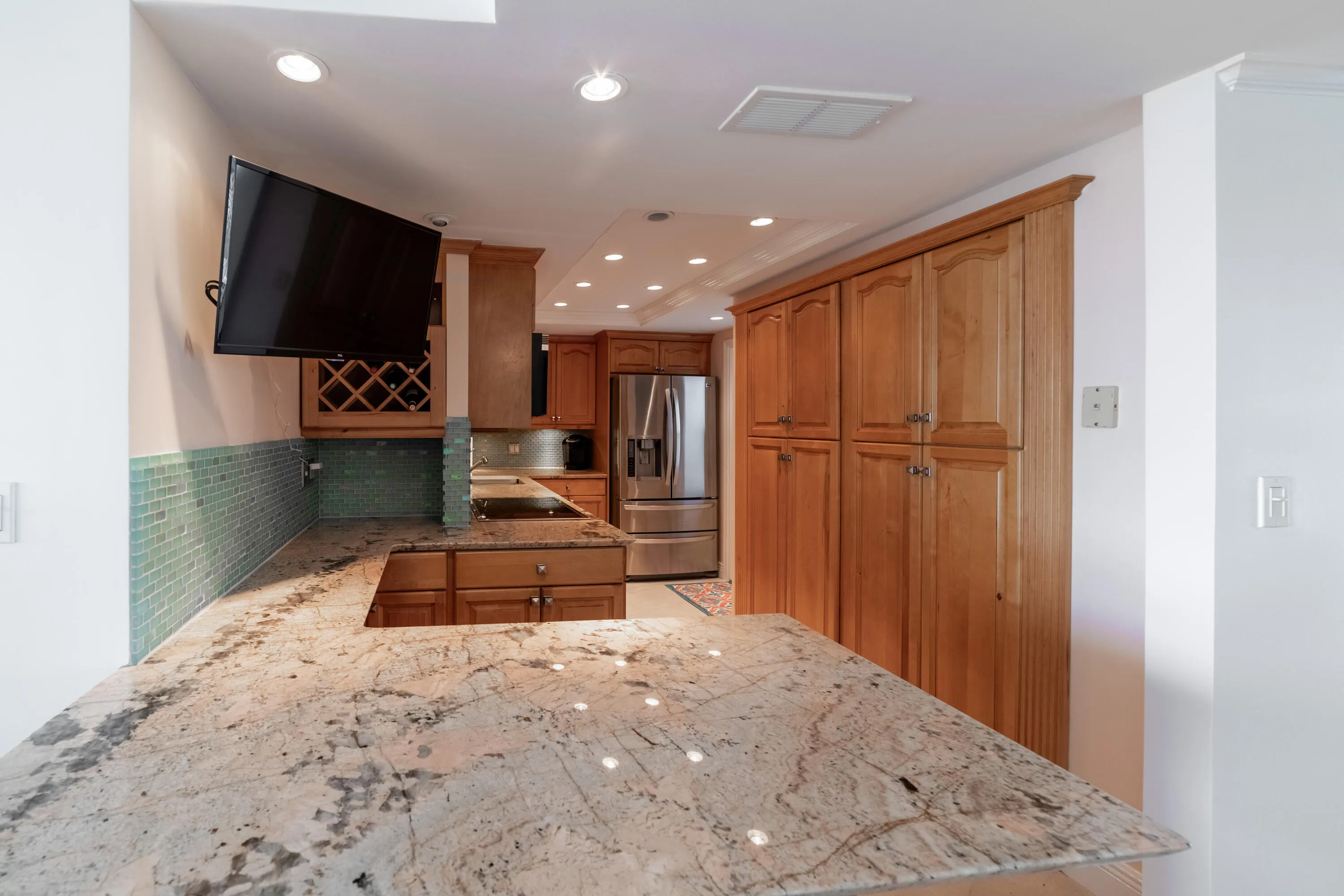 open kitchen with breakfast bar and TV to enjoy the morning news